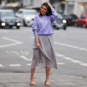 Anna Wolfers seen wearing a purple knit sweater, a light blue midi dress with floral print and light orange heels on June 02, 2022 in Hamburg, Germany.