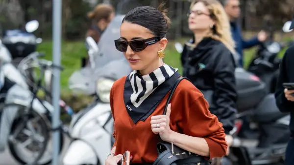 MILAN, ITALY - FEBRUARY 27: Alexandra Pereira wears black leather skirt, scarf, v neck, bag outside Tods during the Milan Fashion Week - Womenswear Fall/Winter 2026/2027 on February 27, 2026 in Milan, Italy. (Photo by Christian Vierig/Getty Images)