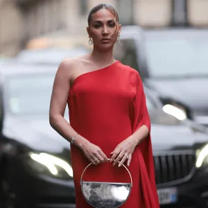 PARIS, FRANCE - JANUARY 23: Ann Kathrin Götze is seen wearing a long red dress with a train, gold hoop earrings by Chopard and a silver metallic handbag during the Stephane Rolland Show Haute Couture Spring/Summer 2024 as part of Paris Fashion Week on January 23, 2024 in Paris, France. (Photo by Jeremy Moeller/Getty Images)