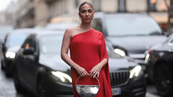 PARIS, FRANCE - JANUARY 23: Ann Kathrin Götze is seen wearing a long red dress with a train, gold hoop earrings by Chopard and a silver metallic handbag during the Stephane Rolland Show Haute Couture Spring/Summer 2024 as part of Paris Fashion Week on January 23, 2024 in Paris, France. (Photo by Jeremy Moeller/Getty Images)