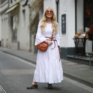 COLOGNE, GERMANY - MARCH 25: Martina Maturi wearing white dress, brown Dior leather belt, brown Dior Bobby bag and Monogramm clogs on March 25, 2021 in Cologne, Germany. (Photo by Jeremy Moeller/Getty Images)