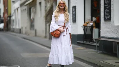 COLOGNE, GERMANY - MARCH 25: Martina Maturi wearing white dress, brown Dior leather belt, brown Dior Bobby bag and Monogramm clogs on March 25, 2021 in Cologne, Germany. (Photo by Jeremy Moeller/Getty Images)