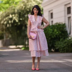 Anna Wolfers wearing white and pink ruffle dress via Goldig Shop, pink Moschino clutch and pink heels on May 31, 2021 in Hamburg, Germany.