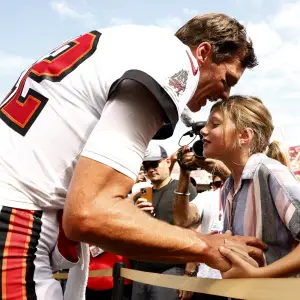 GettyImages-1427328428-Tom-Brady-Passes-Olympic-Torch-to-Daughter-Vivian-Lake-After-Ruling-Out-His-Own-Bid