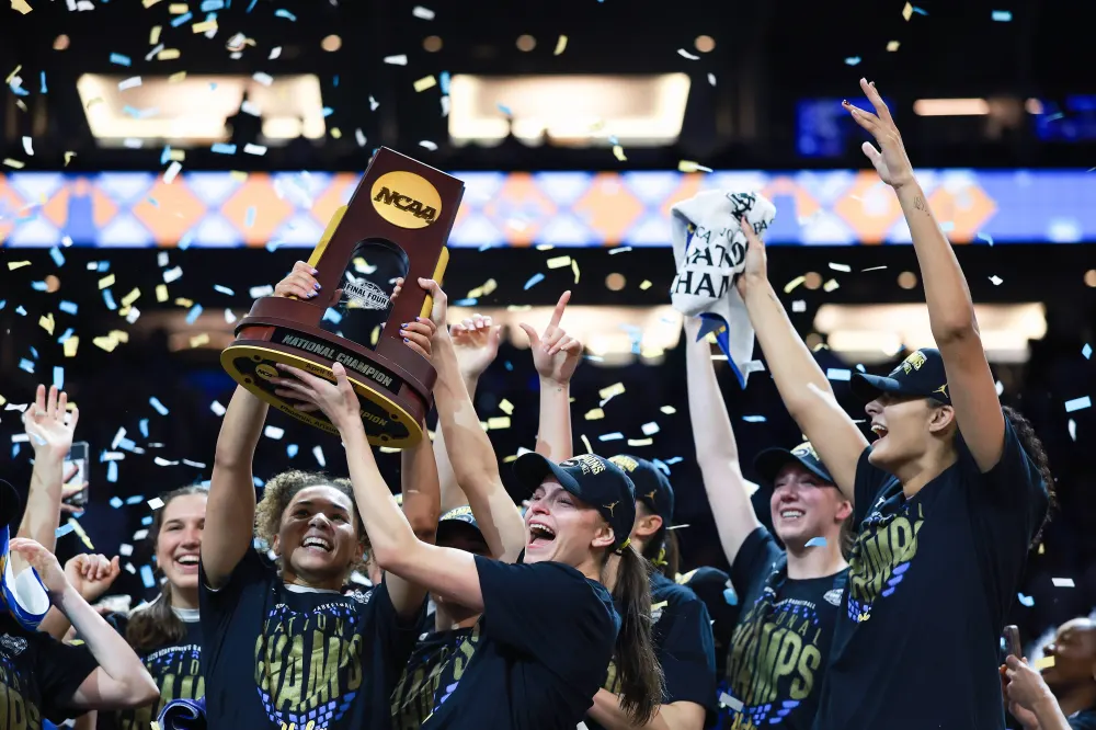 Kiki Rice #1 and Gabriela Jaquez #11 of the UCLA Bruins celebrate with the trophy after the victory against the South Carolina Gamecocks in the National Championship of the NCAA Women's Basketball Tournament at Mortgage Matchup Center on April 05, 2026 in Phoenix, Arizona.