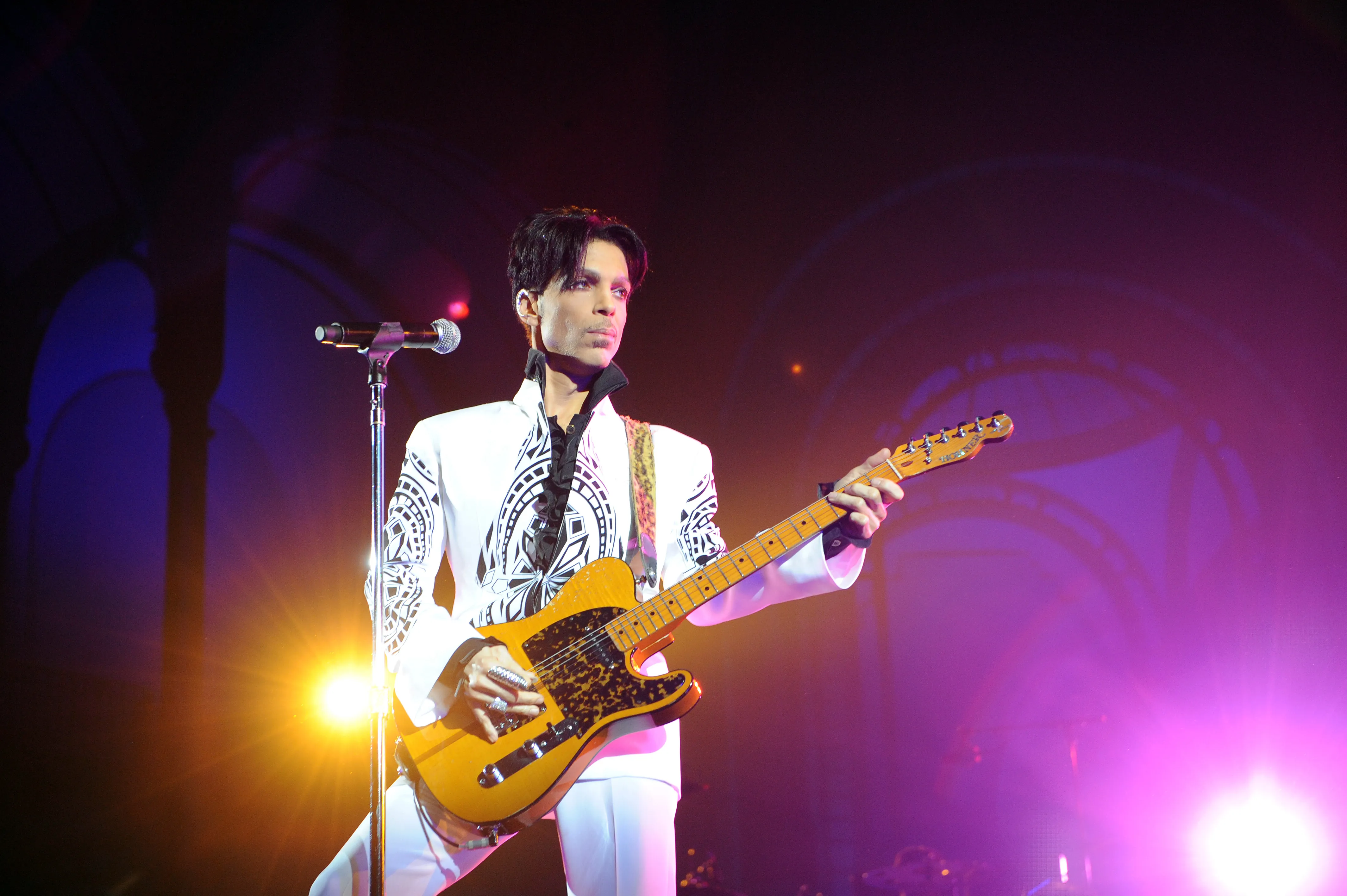 Prince performing with a guitar.