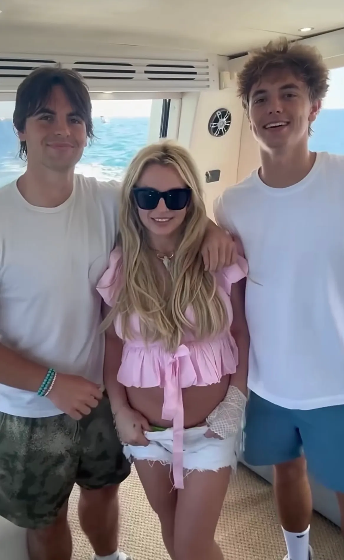 Sean Preston, Britney Spears and Jayden James smiling together on a boat.