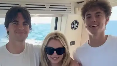 Sean Preston, Britney Spears and Jayden James smiling together on a boat.
