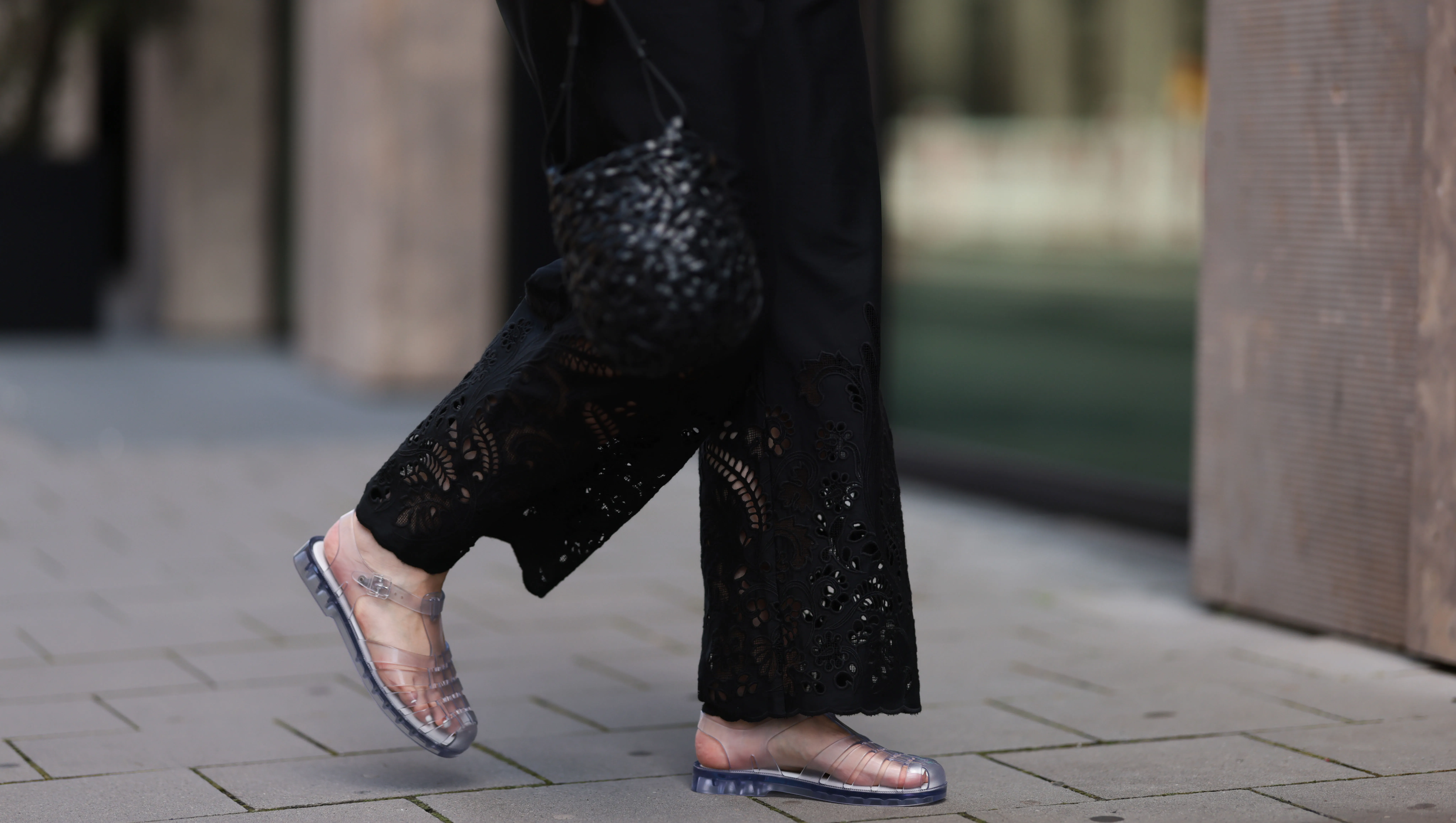 BERLIN, GERMANY - JULY 28: Maria Barteczko seen wearing ARKET black embroidered wide leg trousers, LOEWE black handwoven Nest basket bag and Melissa Possession transparent Jelly fisherman sandals, on July 28, 2024 in Berlin, Germany. (Photo by Jeremy Moeller/Getty Images)