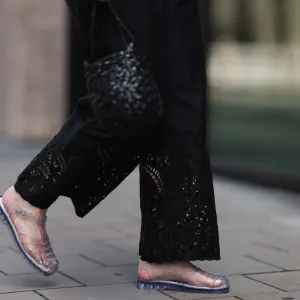 BERLIN, GERMANY - JULY 28: Maria Barteczko seen wearing ARKET black embroidered wide leg trousers, LOEWE black handwoven Nest basket bag and Melissa Possession transparent Jelly fisherman sandals, on July 28, 2024 in Berlin, Germany. (Photo by Jeremy Moeller/Getty Images)