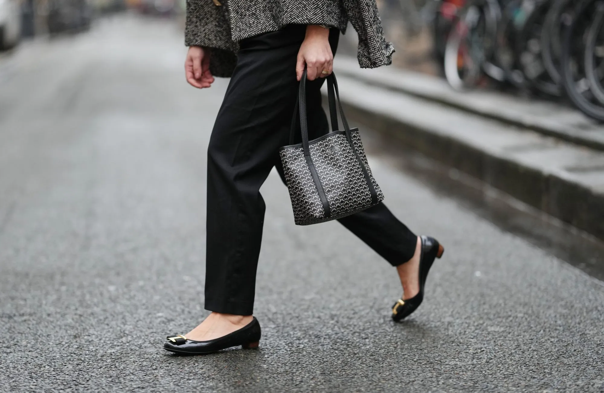 PARIS, FRANCE - JANUARY 12: Maria Rosaria Rizzo wears black Balmain tailored pants with a straight leg, black leather Salvatore Ferragamo ballerina flats with a rounded toe, golden detail and low profile sole, during a street style fashion photo session, on January 12, 2026 in Paris, France. (Photo by Edward Berthelot/Getty Images)