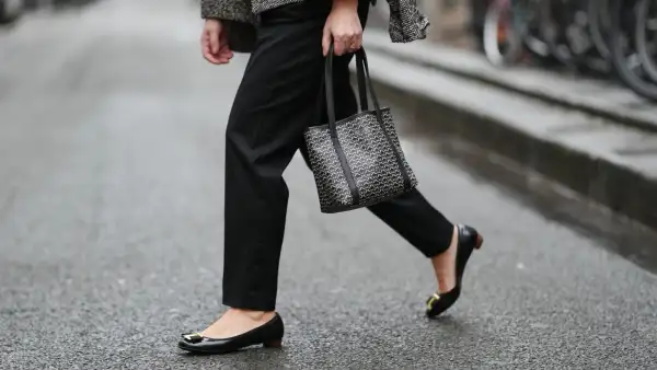 PARIS, FRANCE - JANUARY 12: Maria Rosaria Rizzo wears black Balmain tailored pants with a straight leg, black leather Salvatore Ferragamo ballerina flats with a rounded toe, golden detail and low profile sole, during a street style fashion photo session, on January 12, 2026 in Paris, France. (Photo by Edward Berthelot/Getty Images)