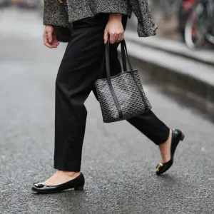 PARIS, FRANCE - JANUARY 12: Maria Rosaria Rizzo wears black Balmain tailored pants with a straight leg, black leather Salvatore Ferragamo ballerina flats with a rounded toe, golden detail and low profile sole, during a street style fashion photo session, on January 12, 2026 in Paris, France. (Photo by Edward Berthelot/Getty Images)