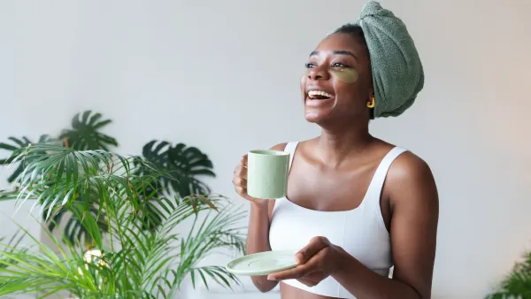 Happy young woman with coffee cup