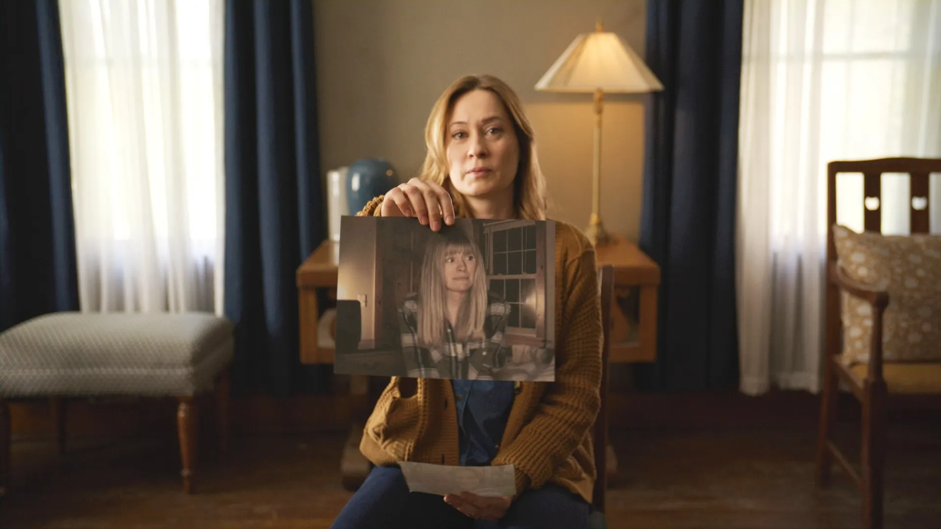 Camille Sullivan, holding a picture of Sarah Durn in Shelby Oaks