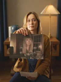 Camille Sullivan, holding a picture of Sarah Durn in Shelby Oaks