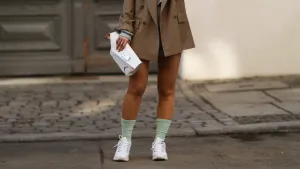 BERLIN, GERMANY - FEBRUARY 22: Masha Sedgwick wearing Maison Margiela white bag, Nike socks, Mango blue jogging two piece, Envelope 1976 beige blazer, brown shades and white Skechers sneaker on February 22, 2021 in Berlin, Germany. (Photo by Jeremy Moeller/Getty Images)