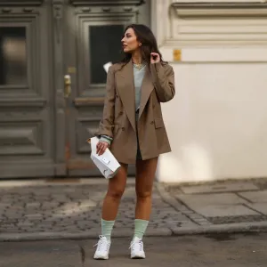 BERLIN, GERMANY - FEBRUARY 22: Masha Sedgwick wearing Maison Margiela white bag, Nike socks, Mango blue jogging two piece, Envelope 1976 beige blazer, brown shades and white Skechers sneaker on February 22, 2021 in Berlin, Germany. (Photo by Jeremy Moeller/Getty Images)