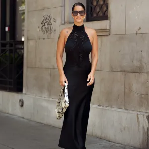 PARIS, FRANCE - JULY 09: Gili Biegun wears a black silk slip dress with lace, snakeskin print shoulder bag, black tassel necklace and sunglasses wears a outside the Elie Saab show during the Haute Couture Fall/Winter 2025/2026 as part of Paris Fashion Week on July 09, 2025 in Paris, France. (Photo by Raimonda Kulikauskiene/Getty Images)