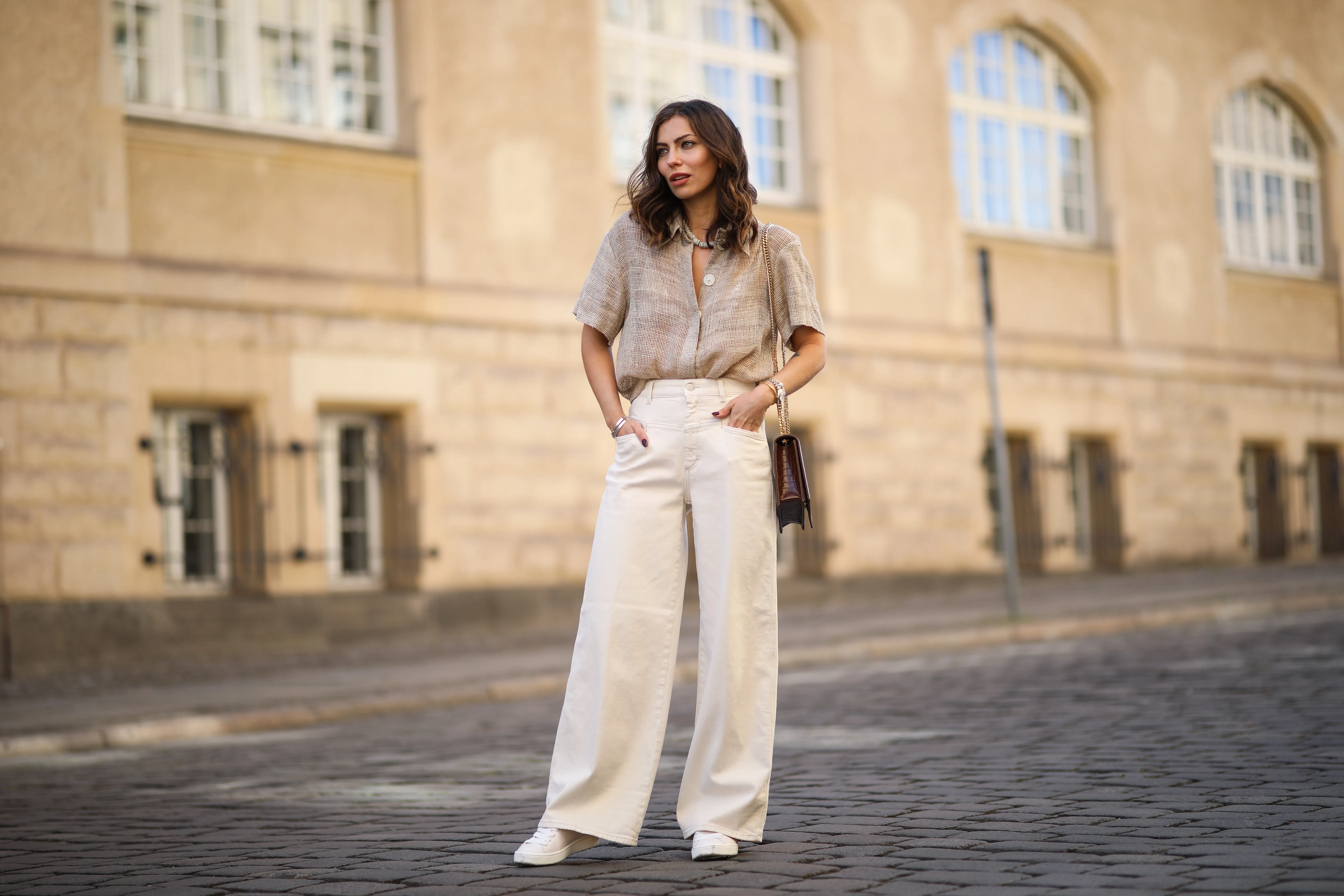 Masha Sedgwick wearing Nobi Talai blouse, Agneel bag, Closed jeans and Coach sneaker on May 06, 2020 in Berlin, Germany.