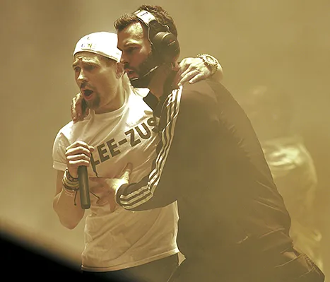 Simon Brodkin is escorted off the stage