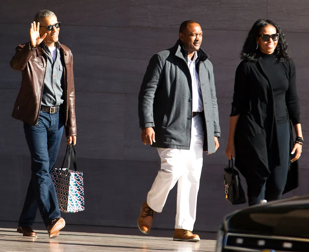 Former President Barack Obama accompanied by former first lady Michelle Obama waves as they leave the National Gallery of Art in Washington, Sunday, March 5, 2017.