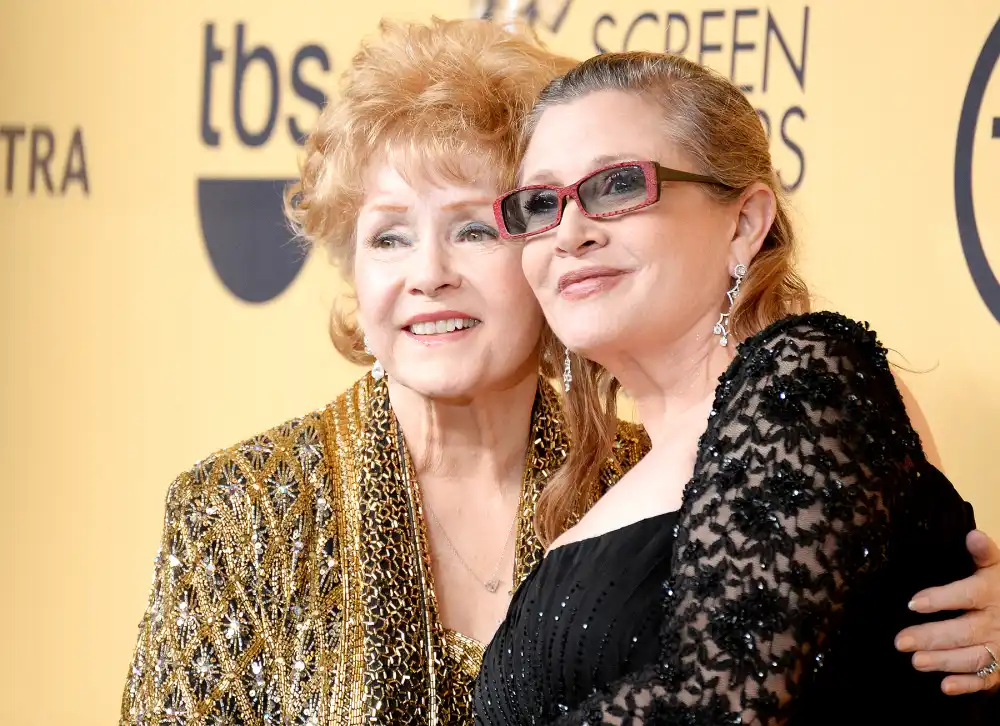Debbie Reynolds and Carrie Fisher pose in the press room at the 21st Annual Screen Actors Guild Awards at The Shrine Auditorium on January 25, 2015 in Los Angeles, California.