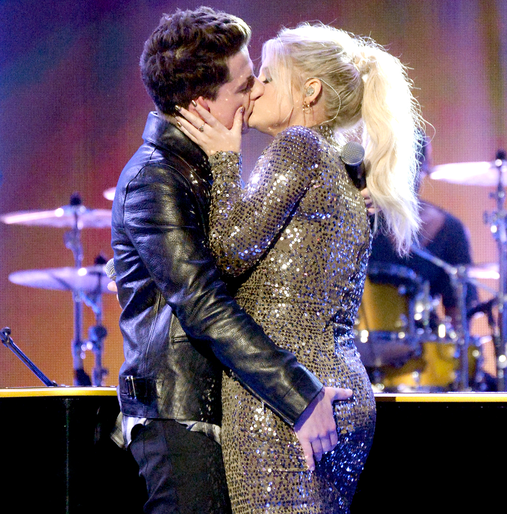 Charlie Puth and Meghan Trainor kiss onstage during the 2015 American Music Awards.