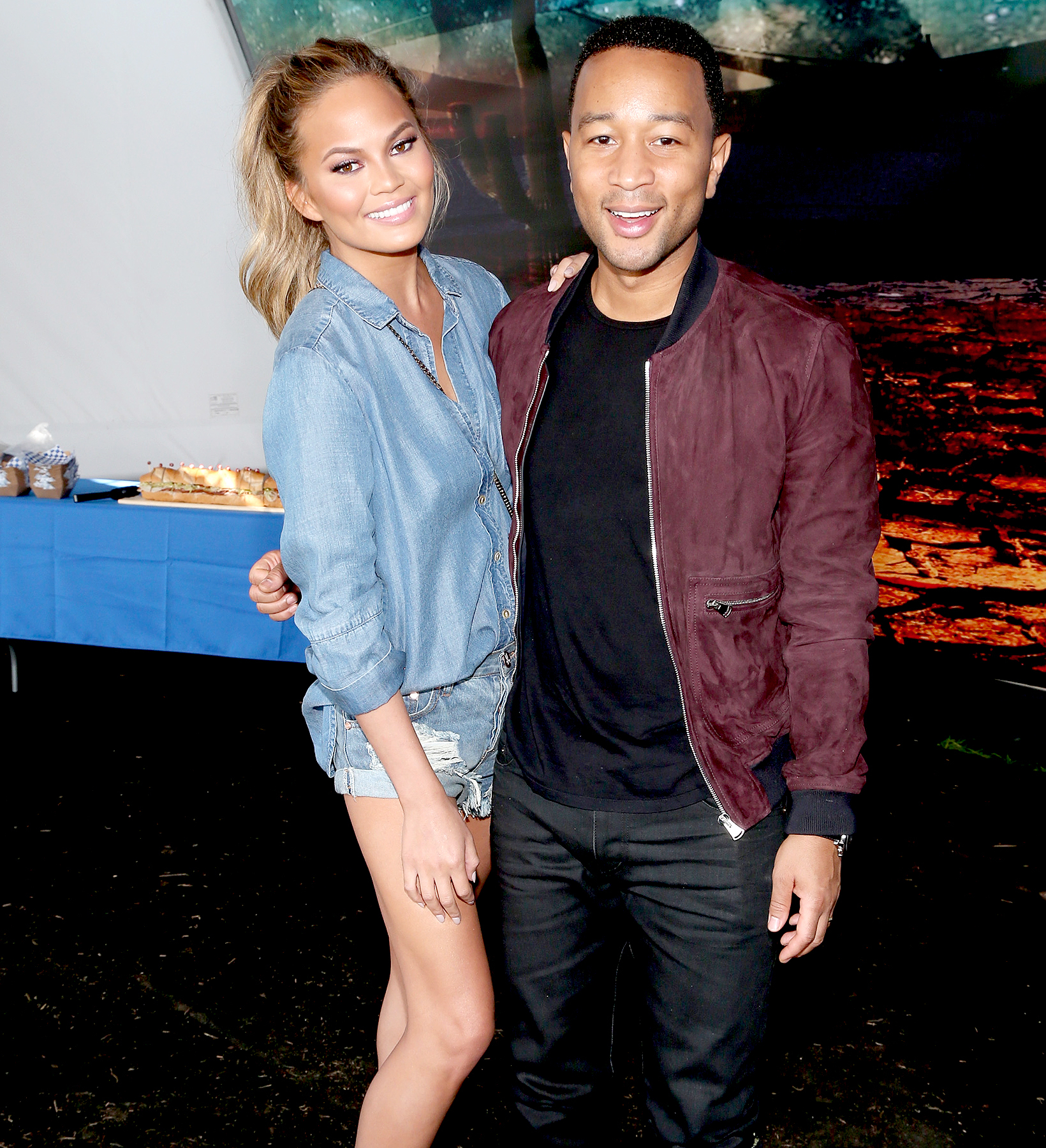 Chrissy Teigen and John Legend attend the DIRECTV Super Fan Tailgate at Pendergast Family Farm on February 1, 2015 in Glendale, Arizona.