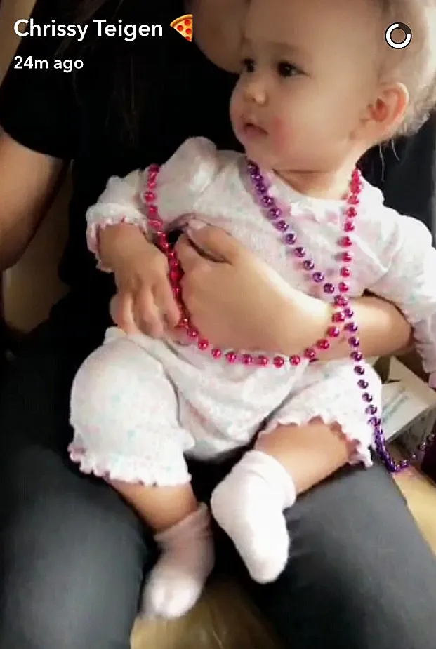 Chrissy Teigen Luna Mardi Gras beads