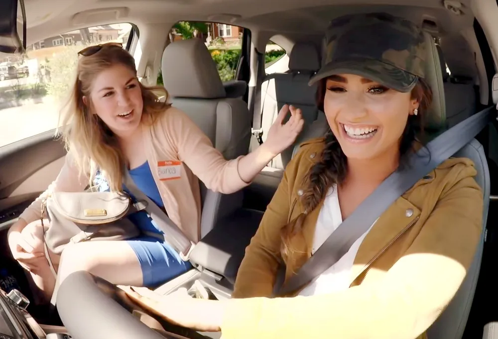 Demi Lovato posing as a Lyft driver