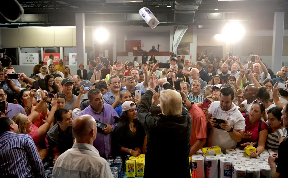 U.S. President Donald Trump throws a paper towel roll as he visits the Cavalry Chapel in Guaynabo, Puerto Rico, on October 3, 2017.