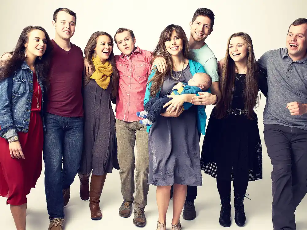 The Duggar family, from left to right: Jinger Duggar, Joseph Duggar, Jana Duggar, Josiah Duggar, Jessa (Duggar) Seewald holding Spurgeon Seewald, Ben Seewald, Joy Anna Duggar, John David Duggar.