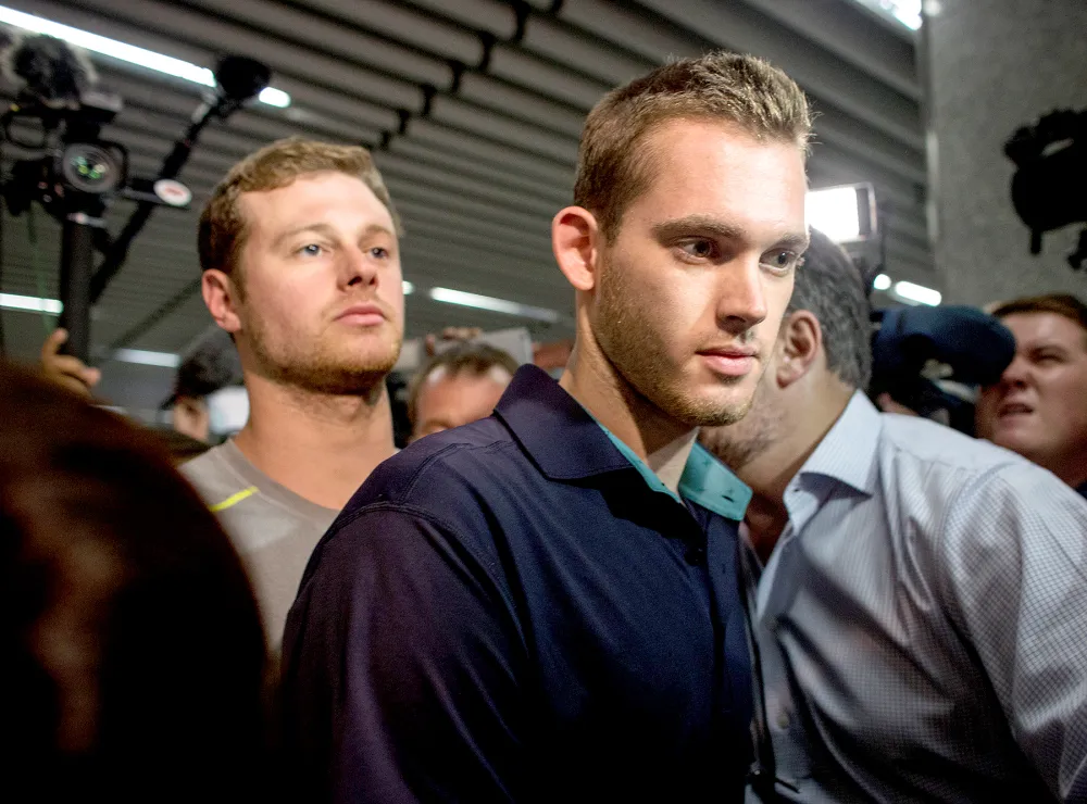U.S Olympic swimmers Gunnar Bentz and Jack Conger leave the police headquarters at international departures of Rio de Janiero&rsquo;s Galeo International airport on Aug. 18, 2016.