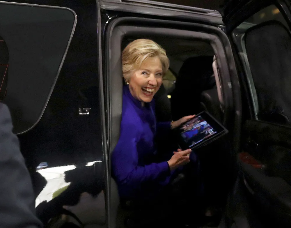 Democratic presidential candidate Hillary Clinton reacts as the Chicago Cubs win the World Series baseball Game 7 against the Cleveland Indians after her final campaign rally of the day at Arizona State University in Tempe, Ariz., Wednesday, Nov. 2, 2016.