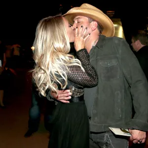 Brittany Kerr and Jason Aldean, winner of the Entertainer of the Year award, kiss at the 51st Academy of Country Music Awards.