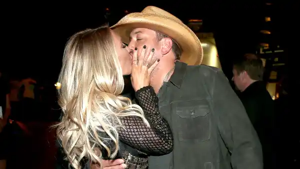 Brittany Kerr and Jason Aldean, winner of the Entertainer of the Year award, kiss at the 51st Academy of Country Music Awards.