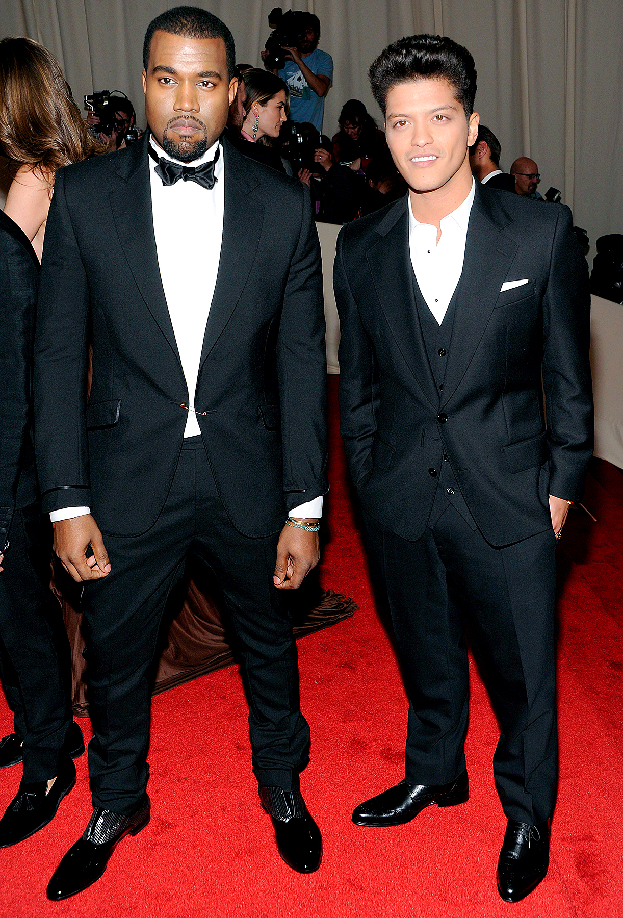 Kanye West, left, and Bruno Mars arrive at the Metropolitan Museum of Art Costume Institute gala benefit, celebrating the 'Alexander McQueen: Savage Beauty' exhibition, Monday, May 2, 2011 in New York.