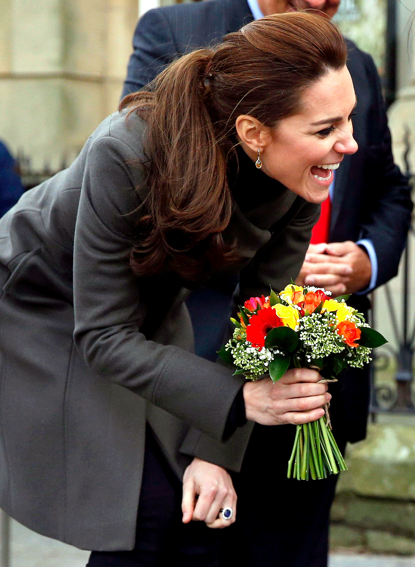 Kate Middleton receives a bunch of flowers from Theo Hayward aged three, as she leaves after visiting a GISDA centre during a visit to Caernarfon on November 20, 2015 in Wales.