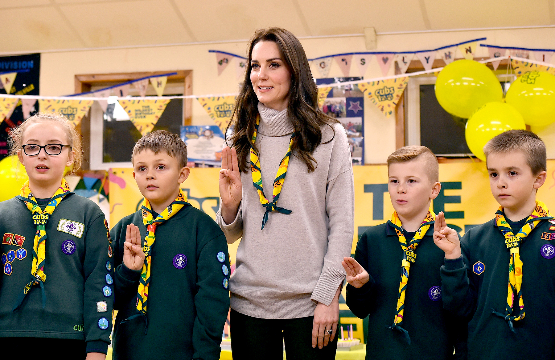 Britain's Catherine, Duchess of Cambridge (C), reads the Scouts promise during a Cub Scout Pack meeting with cubs from the Kings Lynn District, in Kings Lynn, eastern England, on December 14, 2016, to celebrate 100 years of Cubs. The Duchess attended a special Cub Scout Pack meeting with Cubs from the Kings Lynn District to celebrate 100 years of Cubs. Cub Scouting was co-founded by Robert Baden-Powell and Vera Barclay on the 16th December 1916.