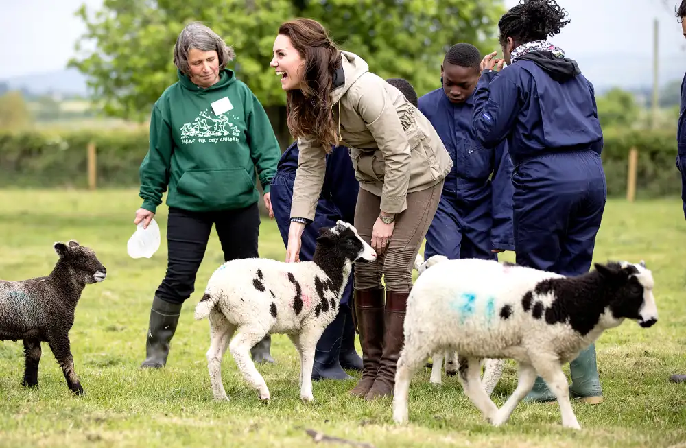 The Duchess of Cambridge with the sheep and lambs and children from Vauxhall primary school in London during a visit to a "Farms for Children" farm on May 3, 2017 in Arlingham, Gloucestershire.