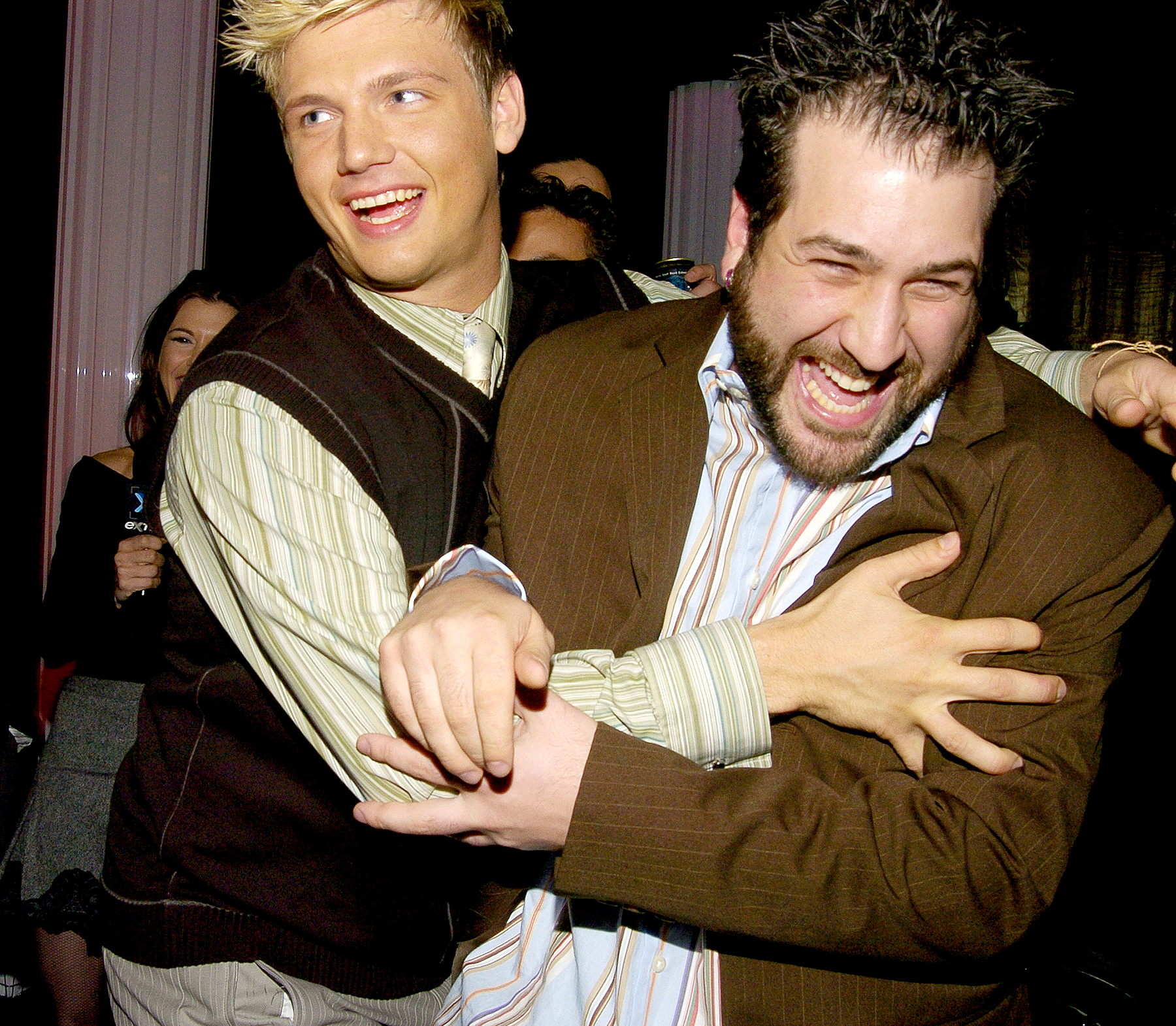 Nick Carter pushes Joey Fatone out of a Backstreet Boys interview in Backstage Creations Talent Retreat at Motown 45 Special in 2004.