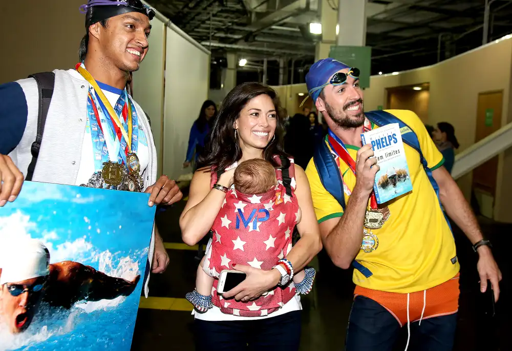 Nicole Johnson, fianc&eacute;e of Michael Phelps, holding their baby son Boomer Phelps pose with fans of Phelps on day 8 of the Rio 2016 Olympic Games at Olympic Aquatics Stadium on August 13, 2016 in Rio de Janeiro, Brazil.