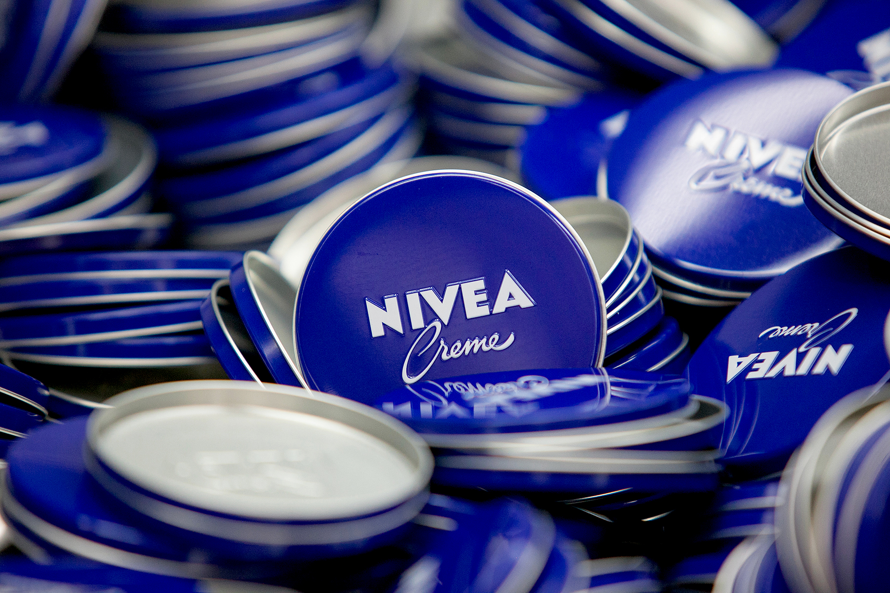 Lids of Nivea Creme skin care lotion tins sit in the production center at the headquarters of Beiersdorf AG in Hamburg, Germany, on Thursday, Feb. 12, 2015.
