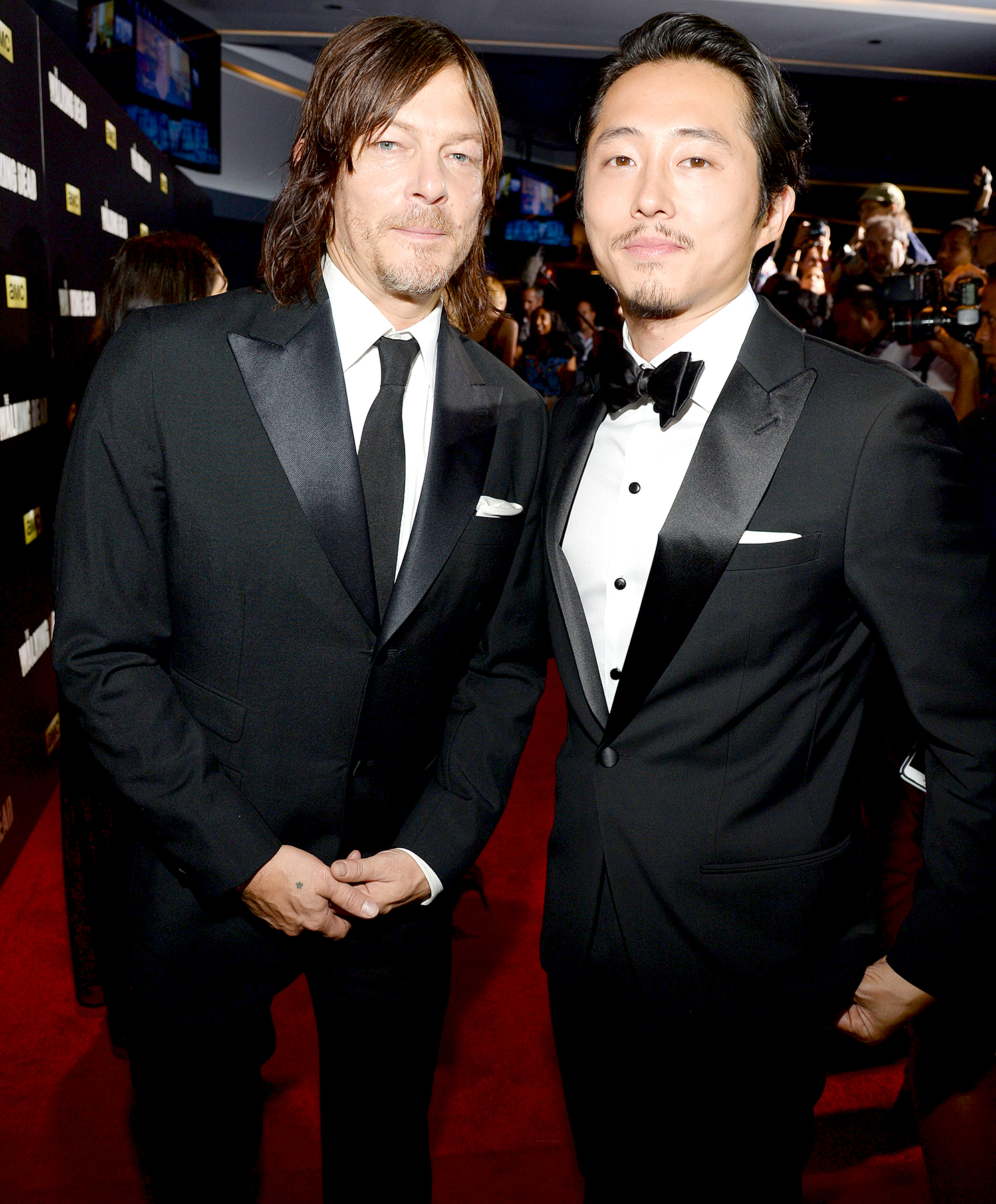 Norman Reedus and Steven Yeun attend AMC's "The Walking Dead" season 6 fan premiere event at Madison Square Garden on October 9, 2015 in New York City.
