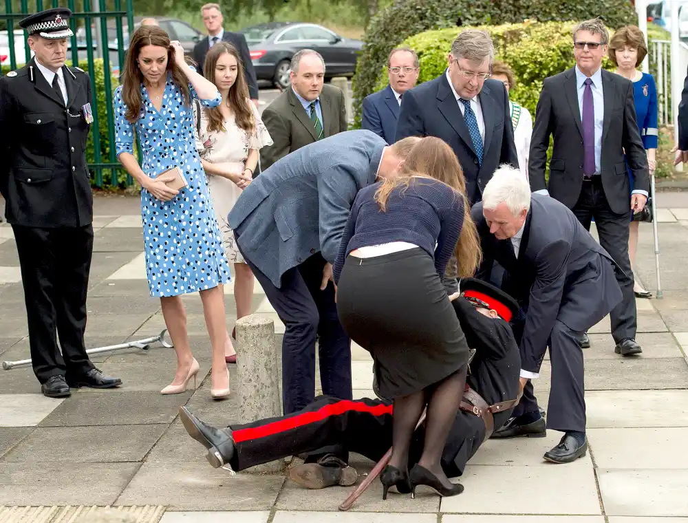 Catherine, Duchess of Cambridge looks on as Prince William, Duke of Cambridge rushes to helpVice Lord Lieutenant of Essex Jonathon Douglas-Hughes who fell backwards over a bollard as they arrive at Steward's Academy on September 16, 2016 in Harlow, England.