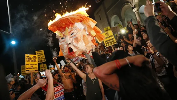 Protesters burn an effigy of Donald Trump outside Los Angeles City Hall.