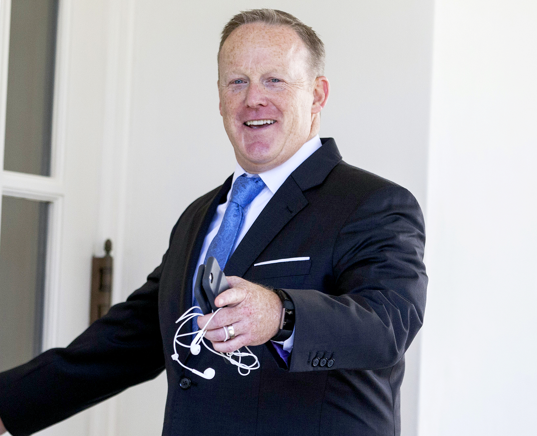 Sean Spicer gestures while entering the West Wing of the White House in Washington, D.C., on July 25, 2017.