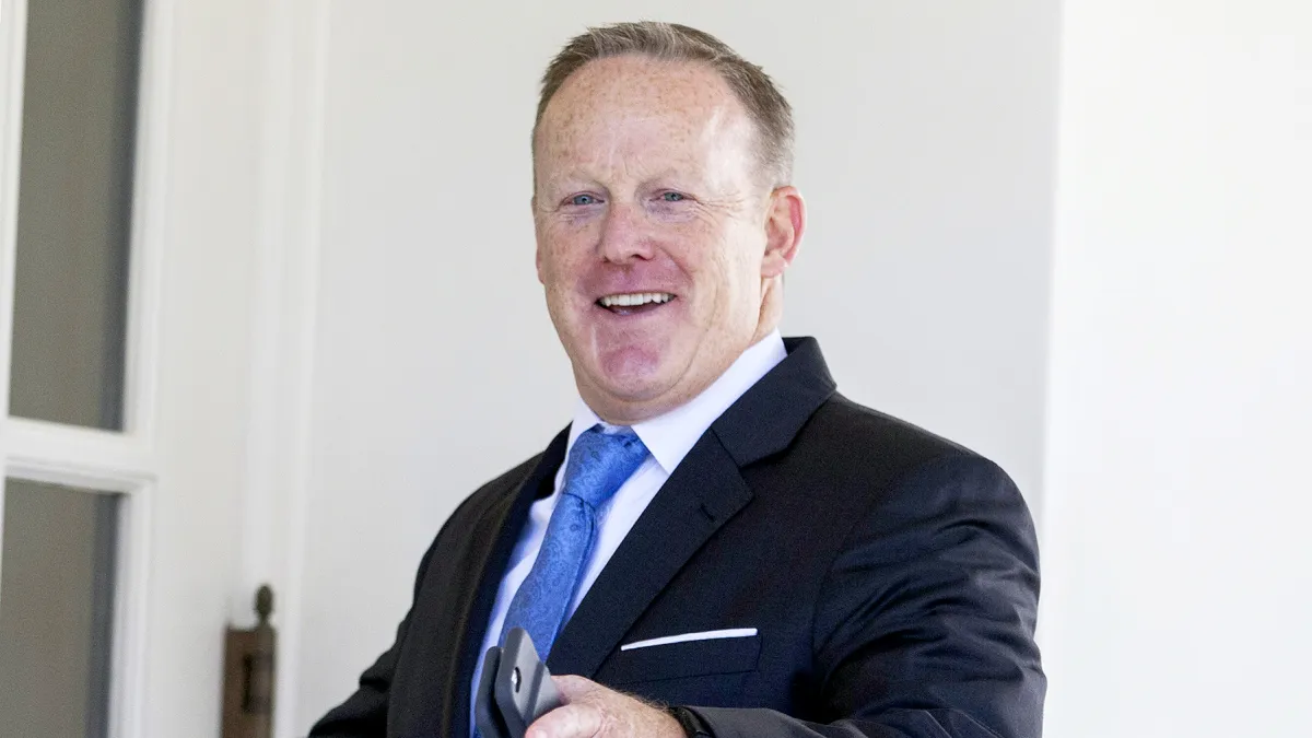 Sean Spicer gestures while entering the West Wing of the White House in Washington, D.C., on July 25, 2017.