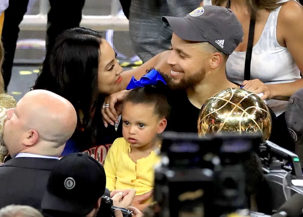 Stephen Curry #30 of the Golden State Warriors celebrates with his wife Ayesha after defeating the Cleveland Cavaliers 129-120 in Game 5 to win the 2017 NBA Finals at ORACLE Arena on June 12, 2017 in Oakland, California.